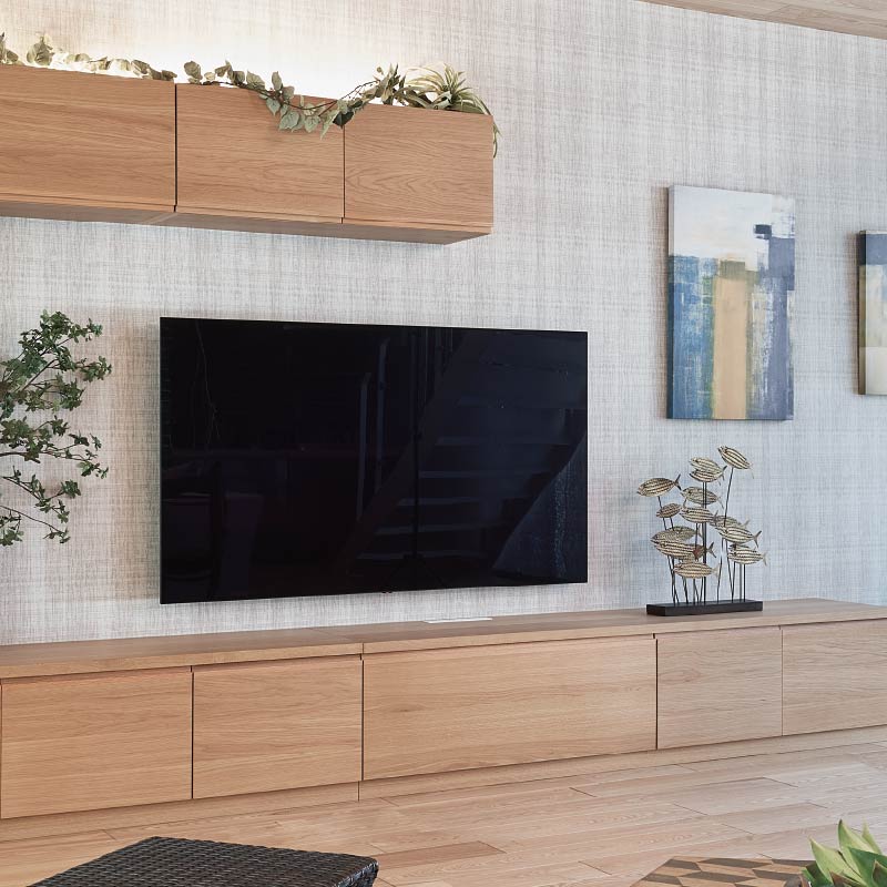 壁掛けテレビと木製のシステムファニチャー。