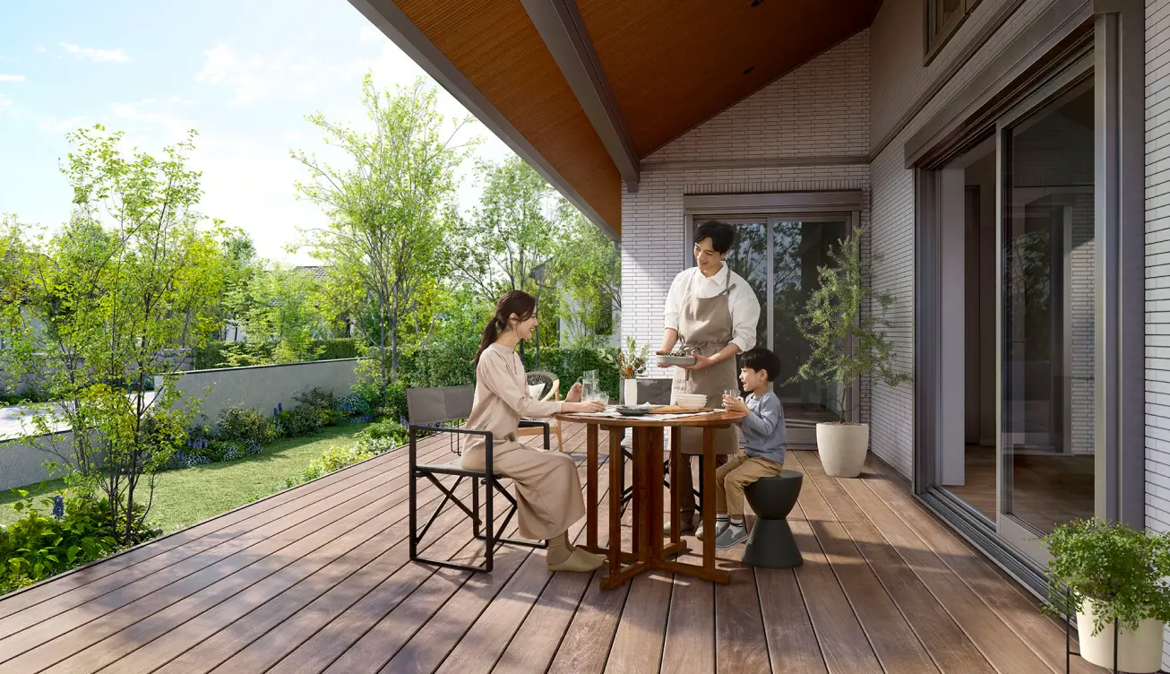 開放的なウッドデッキのテラスで、家族が食事を楽しむ様子